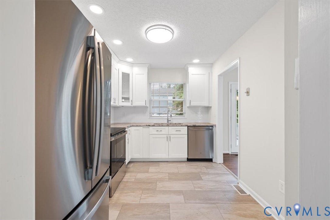 Kitchen featuring stainless steel appliances, white cabinetry, recessed lighting, and tile flooring