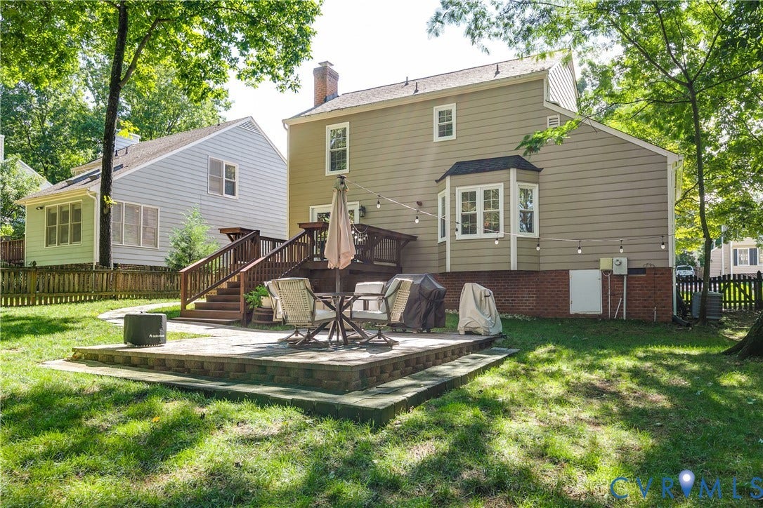 2844 Broadford Lane, Henrico, VA 23233 Expansive backyard featuring a multi-level paver patio, wood deck with stairs, and mature trees