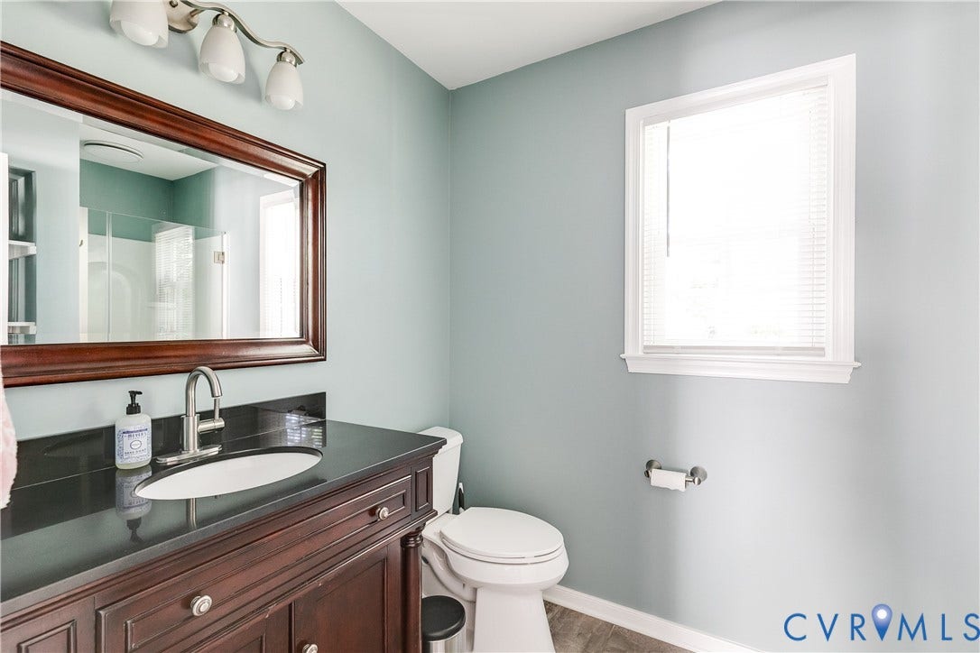 2844 Broadford Lane, Henrico, VA 23233 Vanity with dark wood cabinetry, integrated sink, and dark countertop