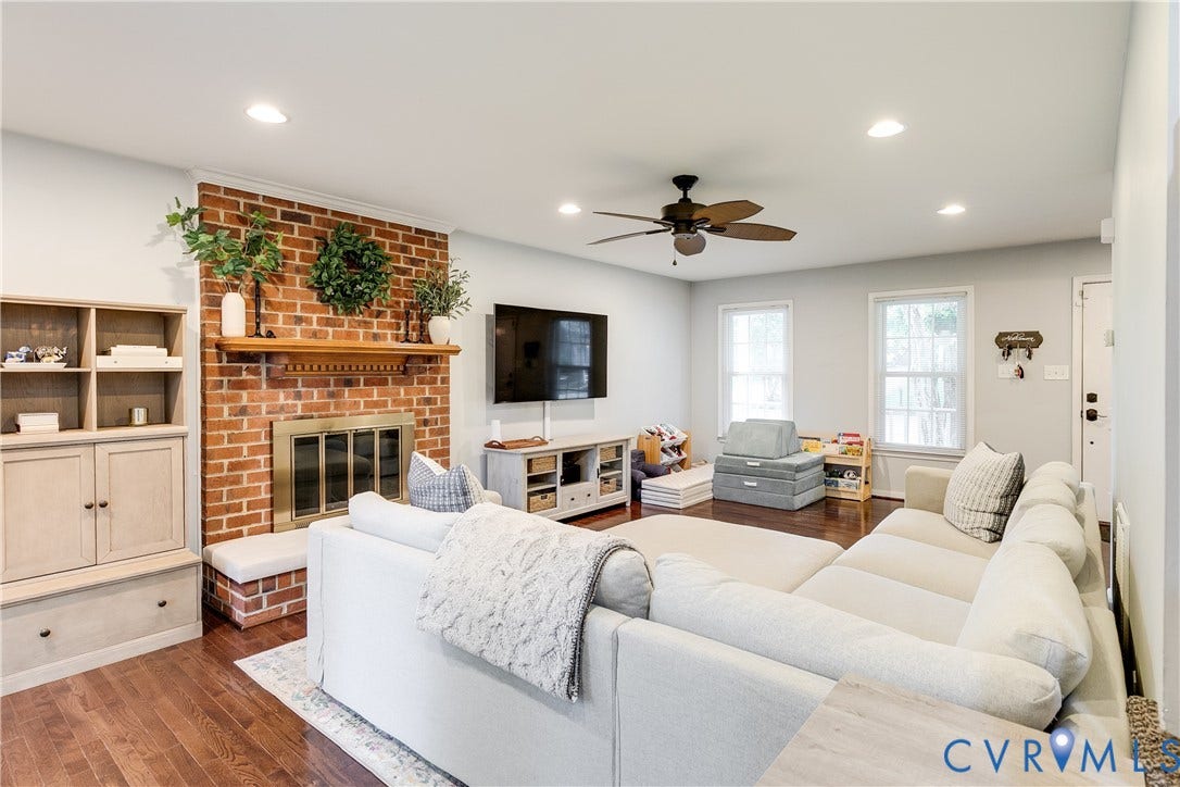 2844 Broadford Lane, Henrico, VA 23233 Brick fireplace with a wood mantle, built-in shelving, wood-finish flooring, recessed lighting, and a ceiling fan