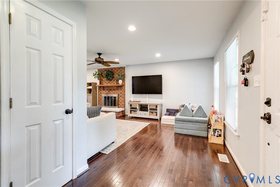 2844 Broadford Lane, Henrico, VA 23233 Wood-finish flooring throughout, recessed lighting, and a brick-surround fireplace with a wood mantle