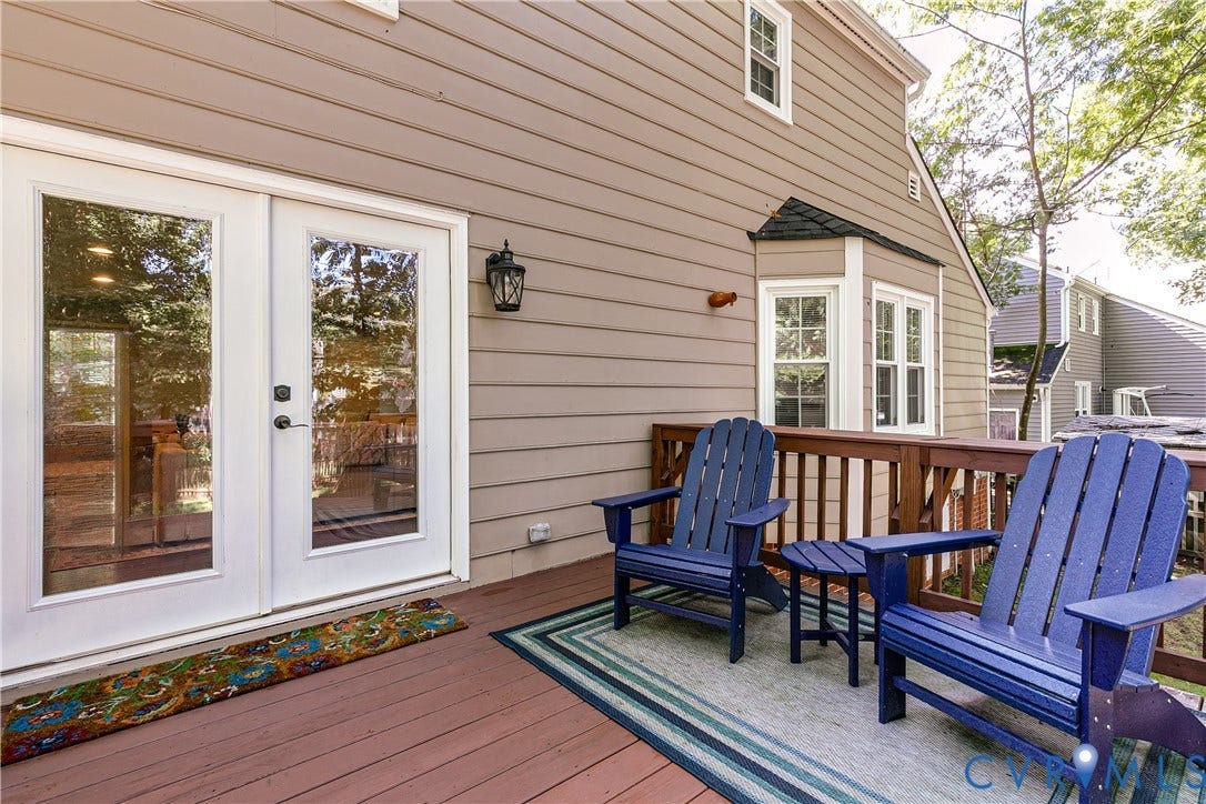 2844 Broadford Lane, Henrico, VA 23233 Expansive wood deck with a wood railing and a wall-mounted exterior light fixture