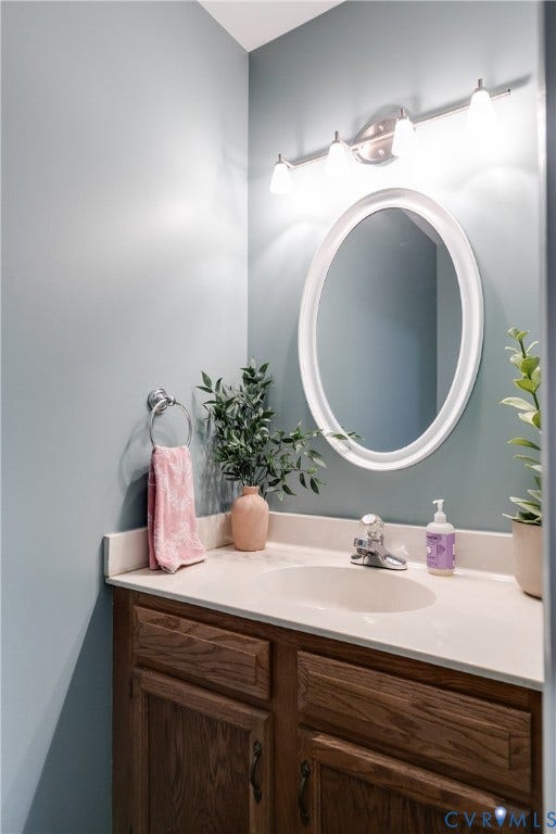 2844 Broadford Lane, Henrico, VA 23233 Spa-inspired bathroom featuring a wood-finish vanity with dual drawers, white quartz countertop, and integrated sink