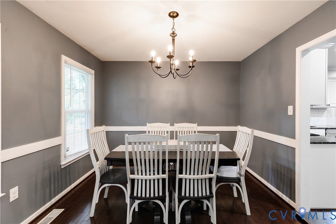 2844 Broadford Lane, Henrico, VA 23233 Dining space featuring dark wood-finish flooring, gray walls with white chair rail molding, and a traditional chandelier