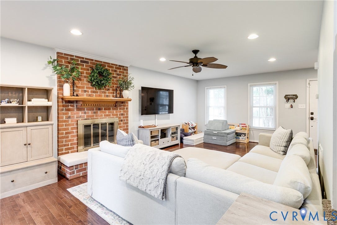 2844 Broadford Lane, Henrico, VA 23233 Living space featuring a brick fireplace with a wood mantle, built-in shelving, recessed lighting, wood-finish flooring, and a ceiling fan