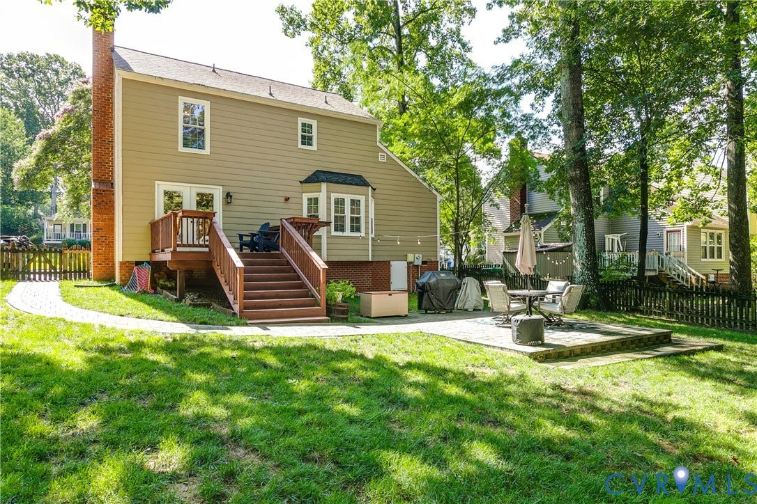 2844 Broadford Lane, Henrico, VA 23233 Spacious backyard featuring a multi-level deck, a paved patio, and a brick chimney
