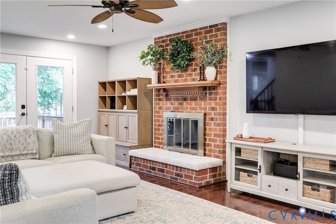 2844 Broadford Lane, Henrico, VA 23233 Brick-faced fireplace with a wood mantle, ceiling fan with integrated lighting, recessed ceiling lights, wood-finish flooring, and double glass-paneled doors