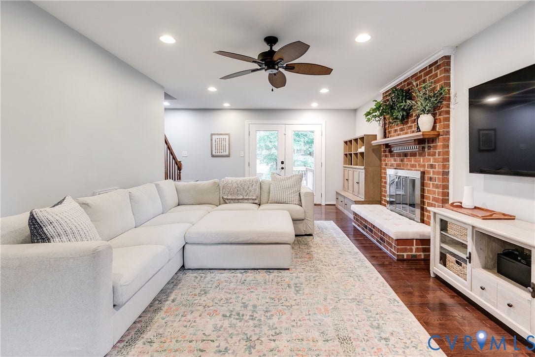 2844 Broadford Lane, Henrico, VA 23233 Brick-clad fireplace with a wood mantle, wood-finish flooring, and recessed ceiling lighting