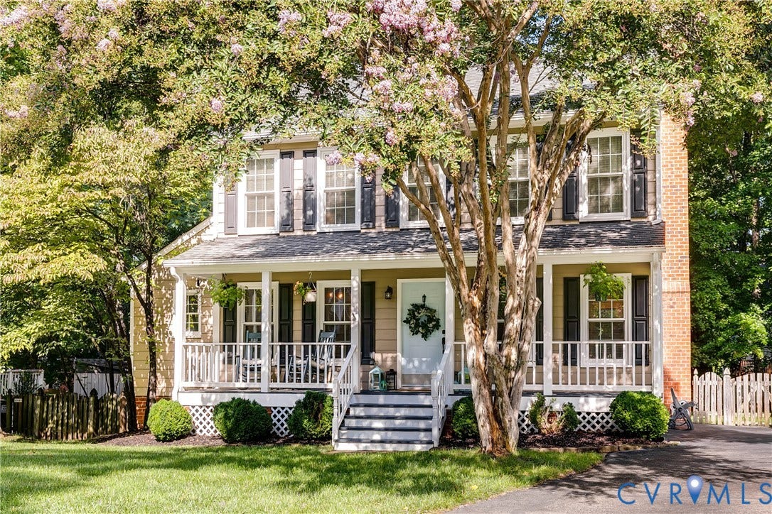 2844 Broadford Lane, Henrico, VA 23233 Charming brick Colonial with white trim and dual dormers, featuring a welcoming front porch with white railings and columns