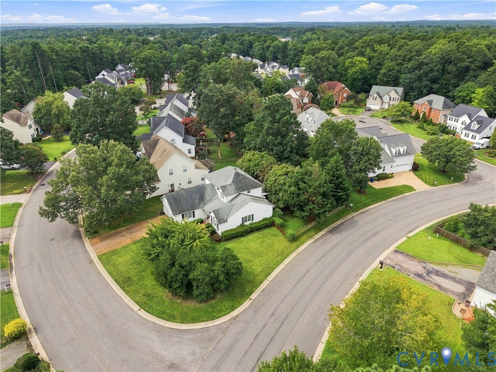 Neighborhood setting with mature trees and paved streets