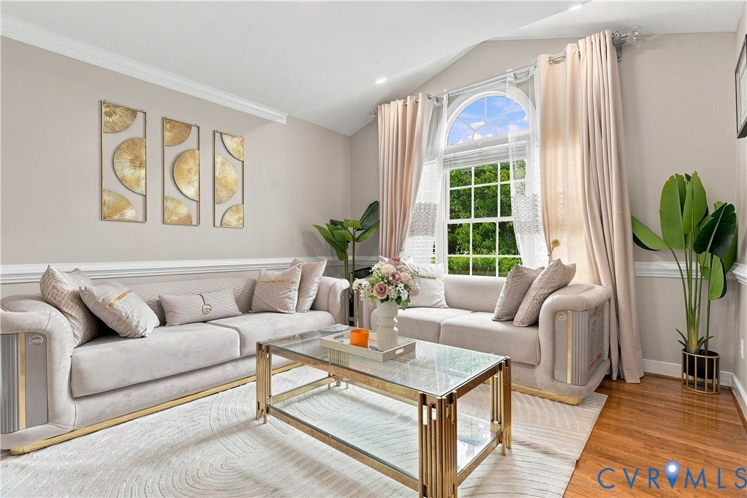 Arched window with transom, crown molding, chair rail molding, vaulted ceiling, and wood-finish flooring
