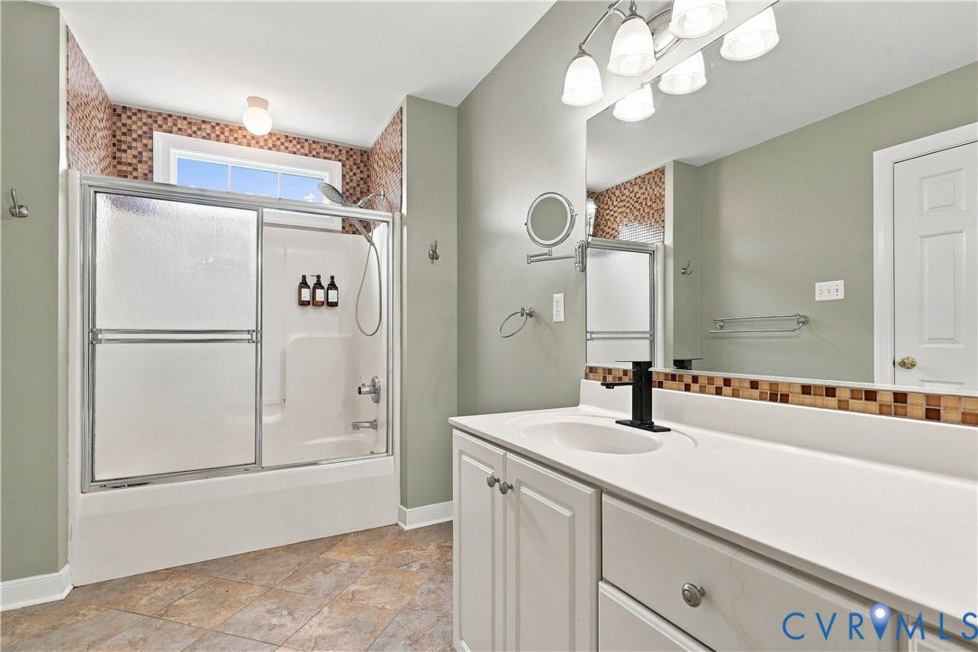 Double vanity with integrated sink, white cabinetry, and matte black faucet