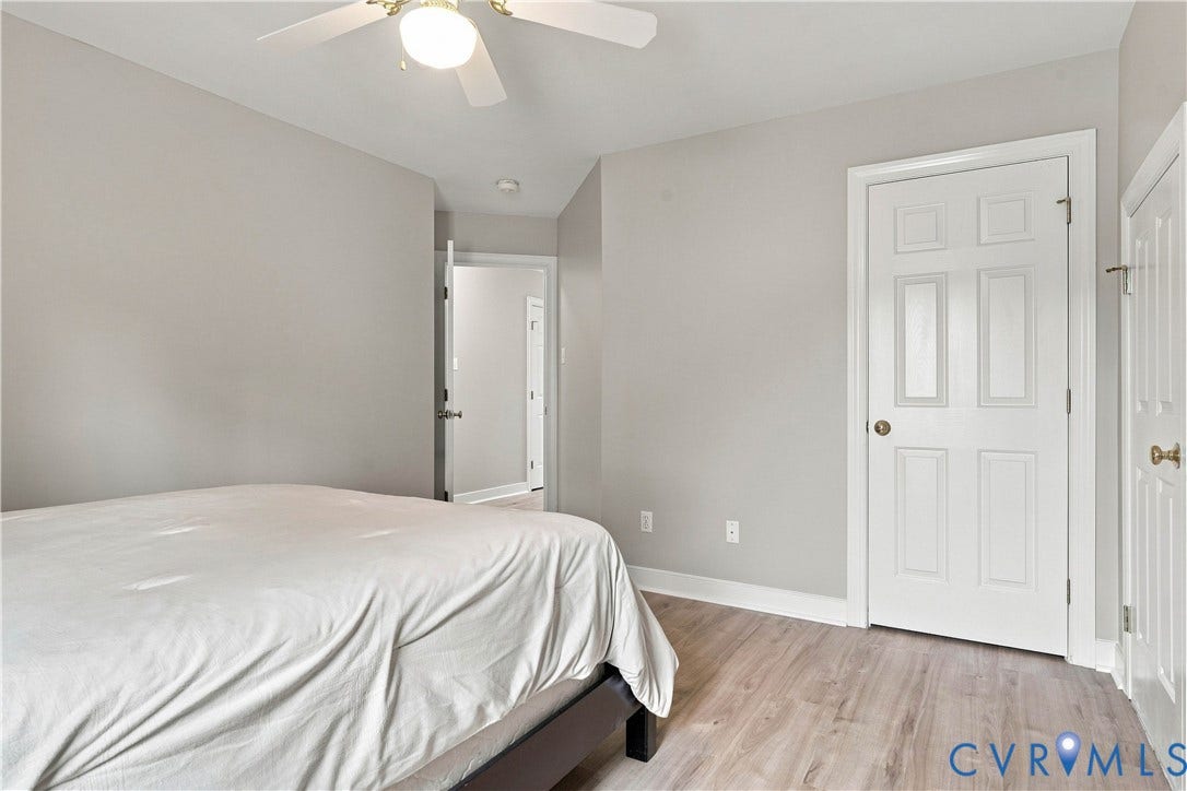 Wood-finish flooring, white paneled doors, ceiling fan with integrated lighting, recessed lighting, and light-toned wall paint