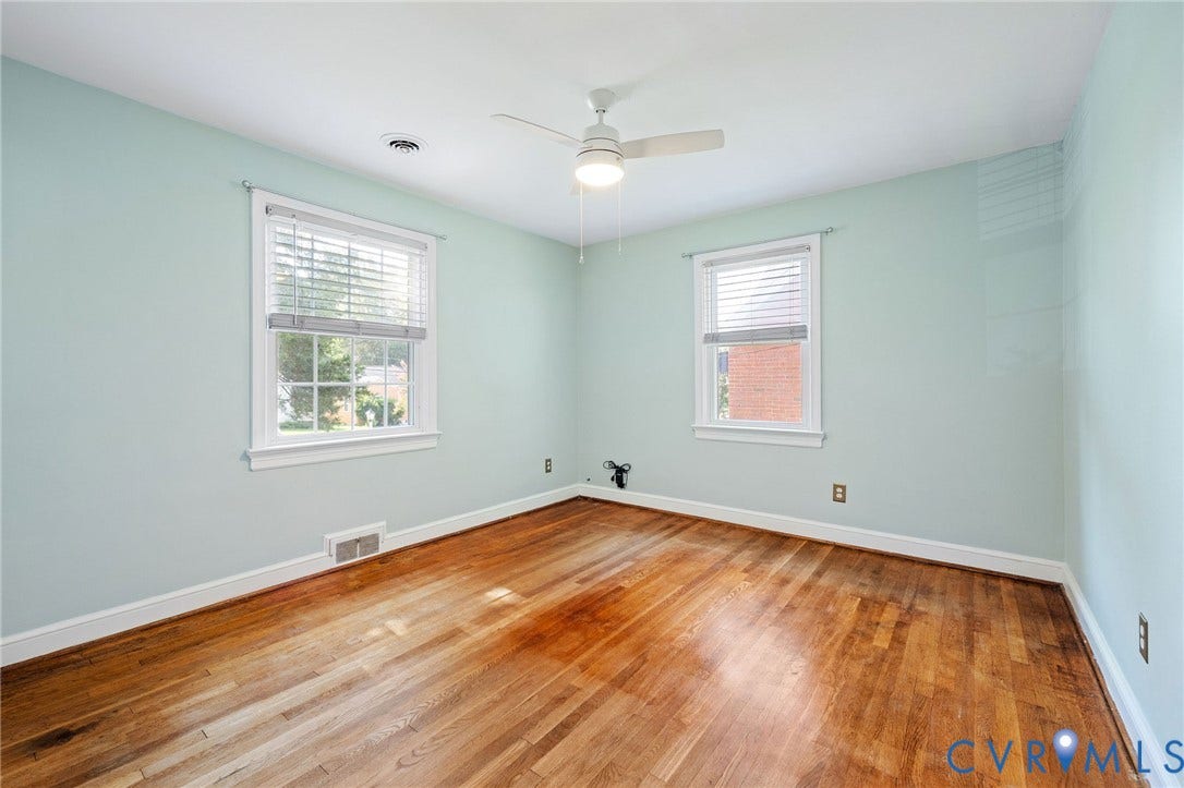 808 W 47th Street, Richmond, VA 23225 Wood-finish flooring, two windows with blinds, and an overhead ceiling fan with lighting