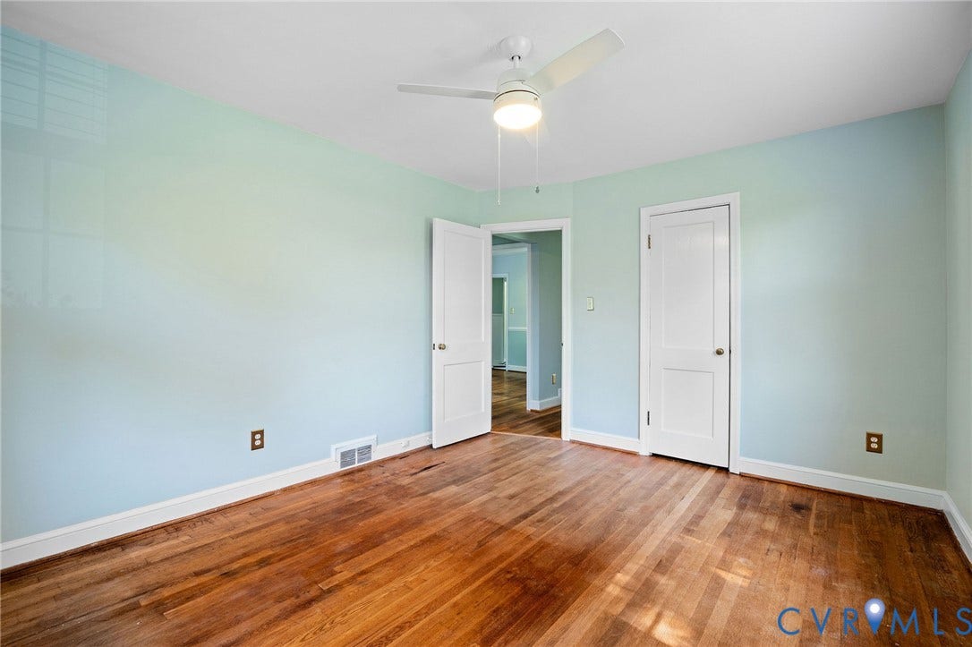 808 W 47th Street, Richmond, VA 23225 Wood-finish flooring with light blue wall paint, white trim, and a ceiling fan with integrated lighting