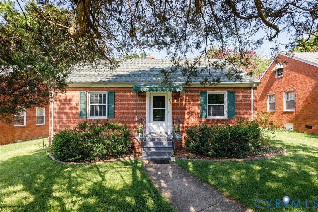 808 W 47th Street, Richmond, VA 23225 Brick exterior with a shingled roof and green shutters