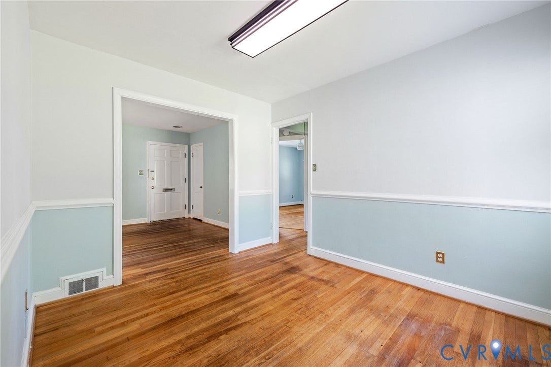 808 W 47th Street, Richmond, VA 23225 Hardwood flooring, chair rail molding, and a flush mount ceiling light