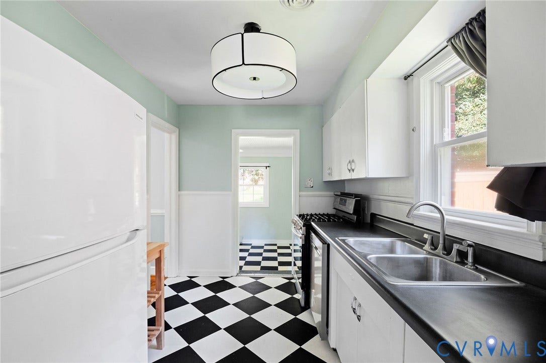 808 W 47th Street, Richmond, VA 23225 Kitchen featuring a checkerboard floor, white cabinetry, double basin sink, and window