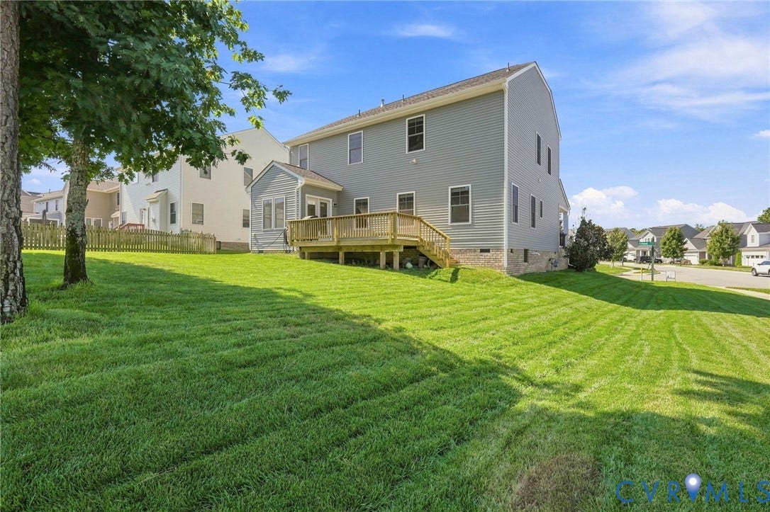 6400 Richwood Trail, Aston Oaks (Section 1), Chesterfield, VA 23120 Expansive green lawn with a multi-level deck, direct access from a sunroom with French doors, and durable vinyl siding