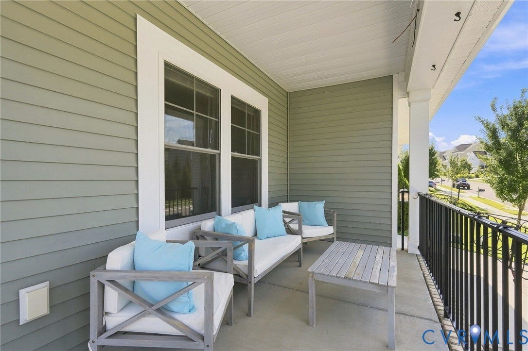 6400 Richwood Trail, Aston Oaks (Section 1), Chesterfield, VA 23120 Covered porch with composite decking, white X-frame seating, and blue cushions overlooking the neighborhood