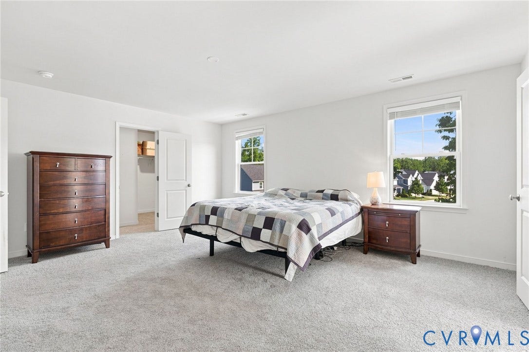 6400 Richwood Trail, Aston Oaks (Section 1), Chesterfield, VA 23120 Light-toned carpeting, white painted walls, two windows with white trim, and a doorway leading to a separate area with wood-finish flooring