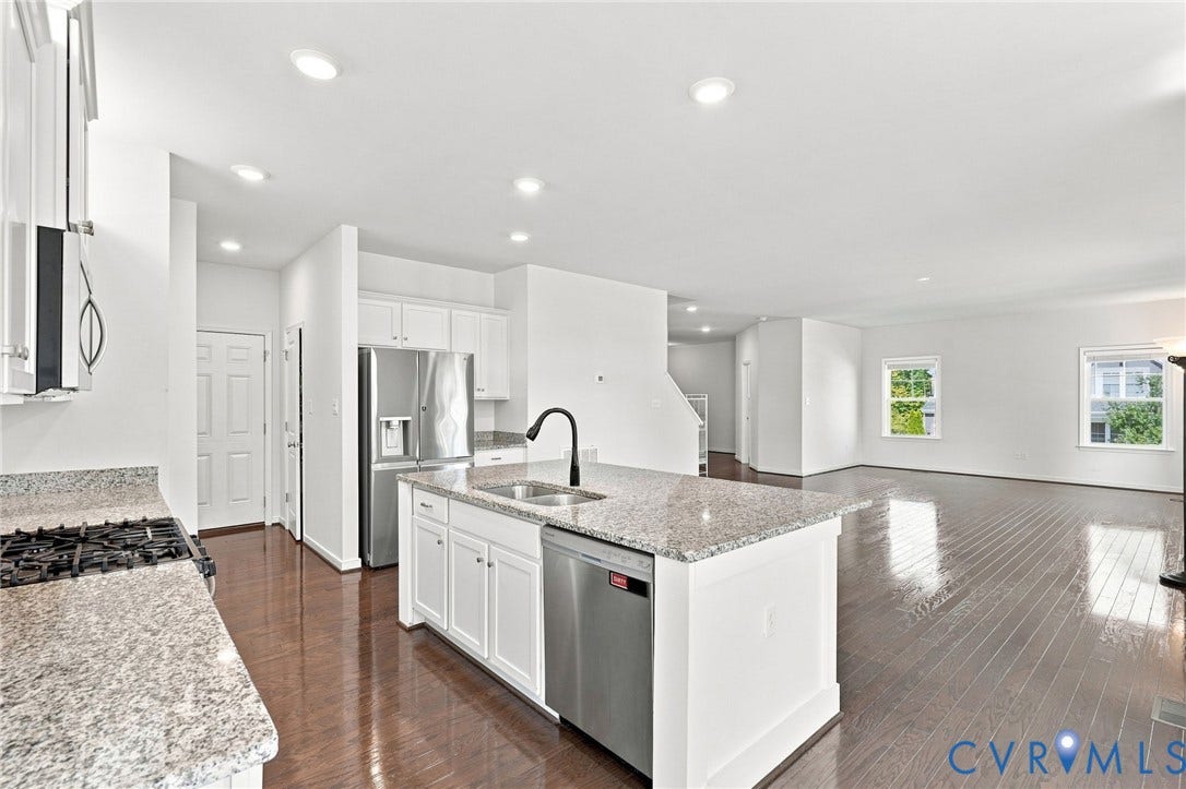 6400 Richwood Trail, Aston Oaks (Section 1), Chesterfield, VA 23120 Open-concept kitchen and living area featuring granite countertops, stainless steel appliances, white cabinetry, and wood-finish flooring