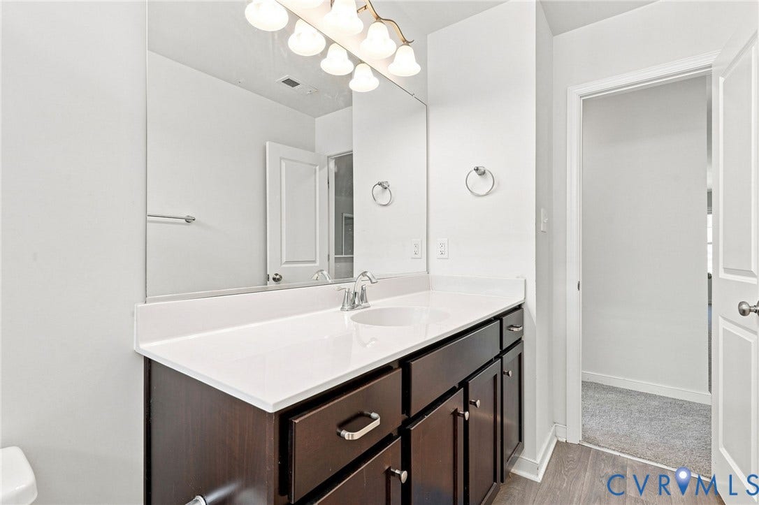 6400 Richwood Trail, Aston Oaks (Section 1), Chesterfield, VA 23120 Bathroom vanity with a white countertop, undermount sink, and dark wood-finish cabinetry