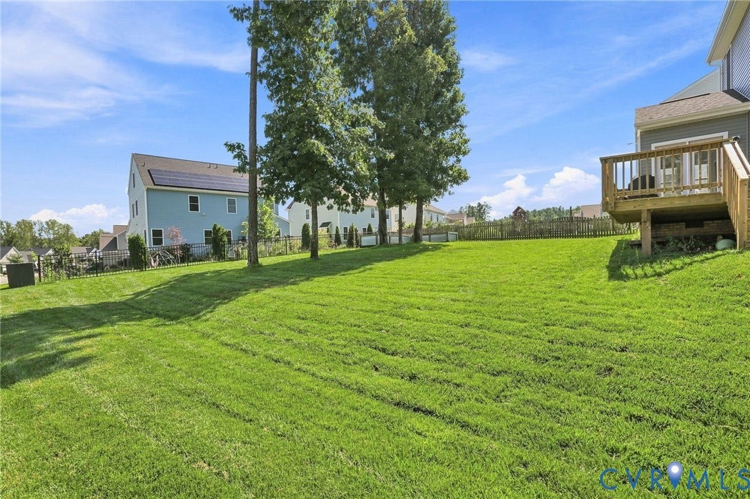 6400 Richwood Trail, Aston Oaks (Section 1), Chesterfield, VA 23120 Expansive green lawn with a wood deck and privacy fencing