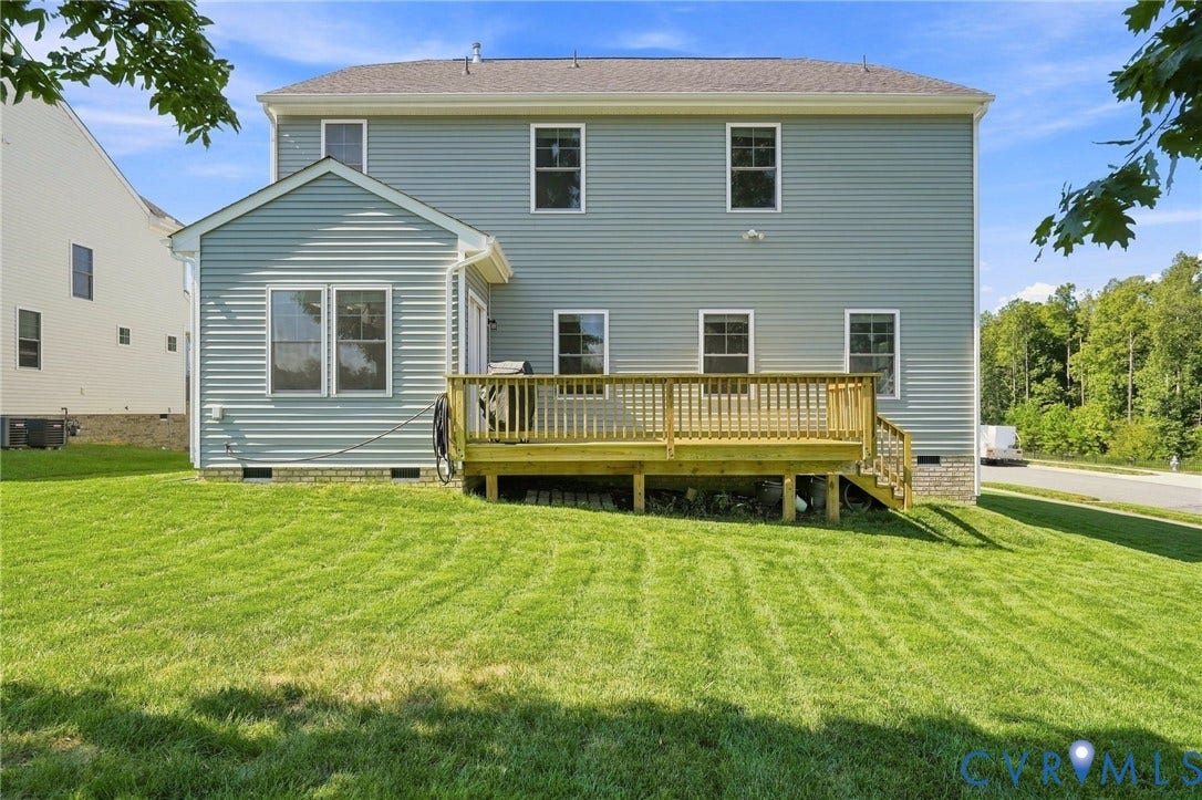 6400 Richwood Trail, Aston Oaks (Section 1), Chesterfield, VA 23120 Expansive green lawn, multi-level wood deck, light blue vinyl siding, white window trim, and a partial brick foundation