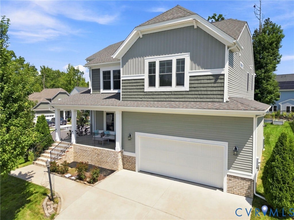 6400 Richwood Trail, Aston Oaks (Section 1), Chesterfield, VA 23120 Two-story home featuring a brick and composite siding exterior with a front-load two-car garage, covered front porch with white railings, and multi-pane windows