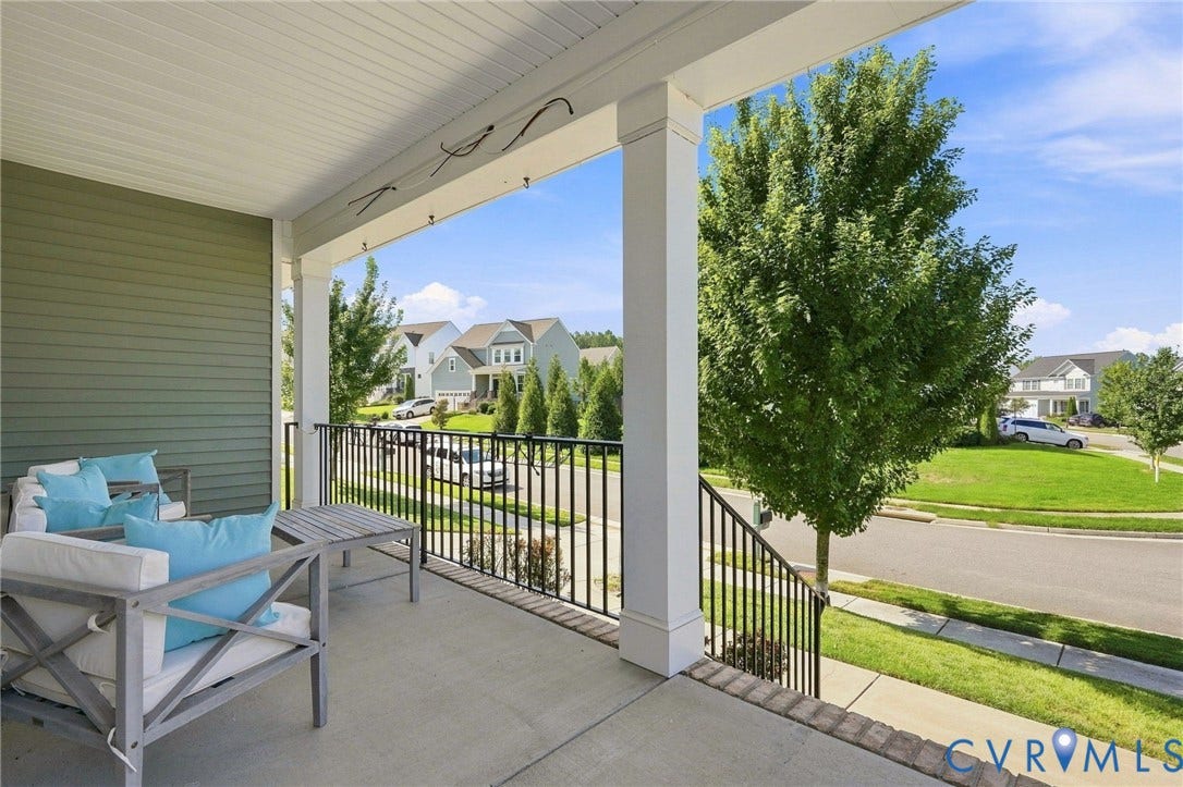 6400 Richwood Trail, Aston Oaks (Section 1), Chesterfield, VA 23120 Expansive covered porch featuring composite decking, black aluminum railings, and white painted columns overlooking manicured lawn and mature landscaping