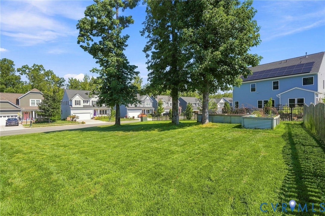 6400 Richwood Trail, Aston Oaks (Section 1), Chesterfield, VA 23120 Expansive green lawn with mature trees, a private fenced yard, and raised garden beds