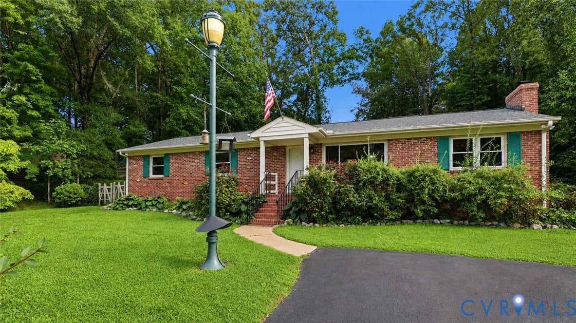 11201 Monday Way, Chesterfield, VA 23112 Brick exterior with green shutters, a paved driveway, and a front walkway