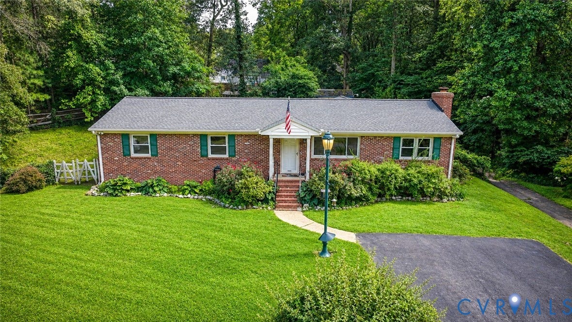 11201 Monday Way, Chesterfield, VA 23112 Brick exterior with green window shutters, dark shingle roof, and a prominent chimney