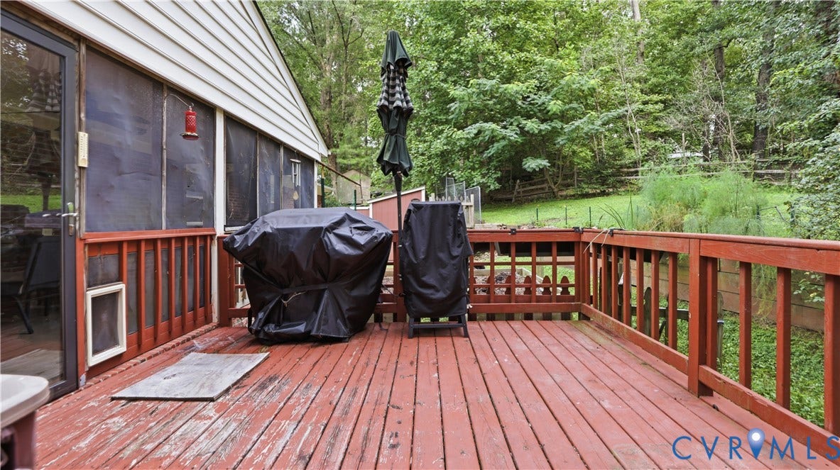 11201 Monday Way, Chesterfield, VA 23112 Expansive wood deck with a red finish, featuring a full railing system, and a screened-in porch with a glass-paneled door
