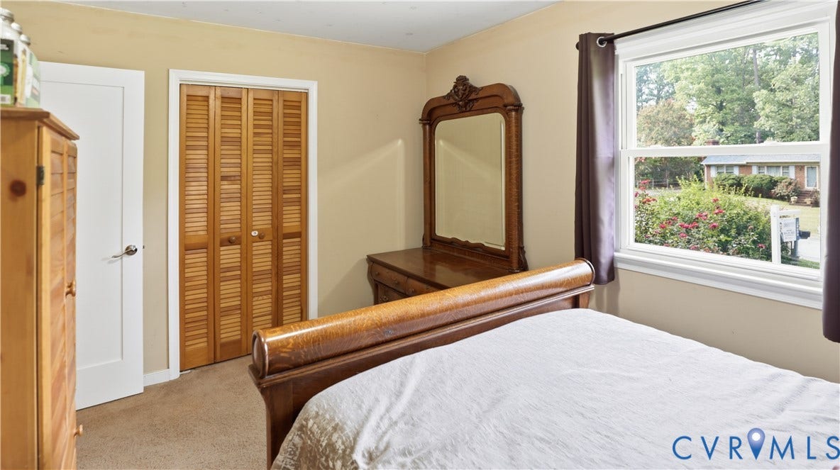 11201 Monday Way, Chesterfield, VA 23112 Wood-finish louvered bi-fold closet doors, white interior door, and a single-pane window