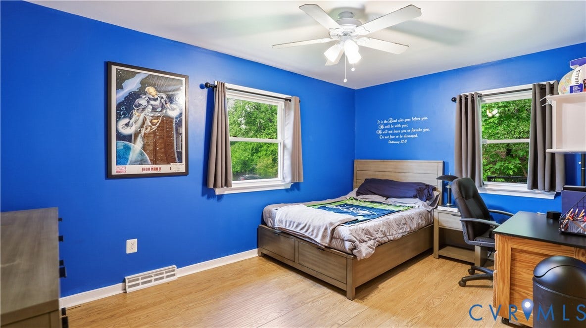 11201 Monday Way, Chesterfield, VA 23112 Wood-finish flooring, bright blue walls, two windows, and a ceiling fan with integrated lighting