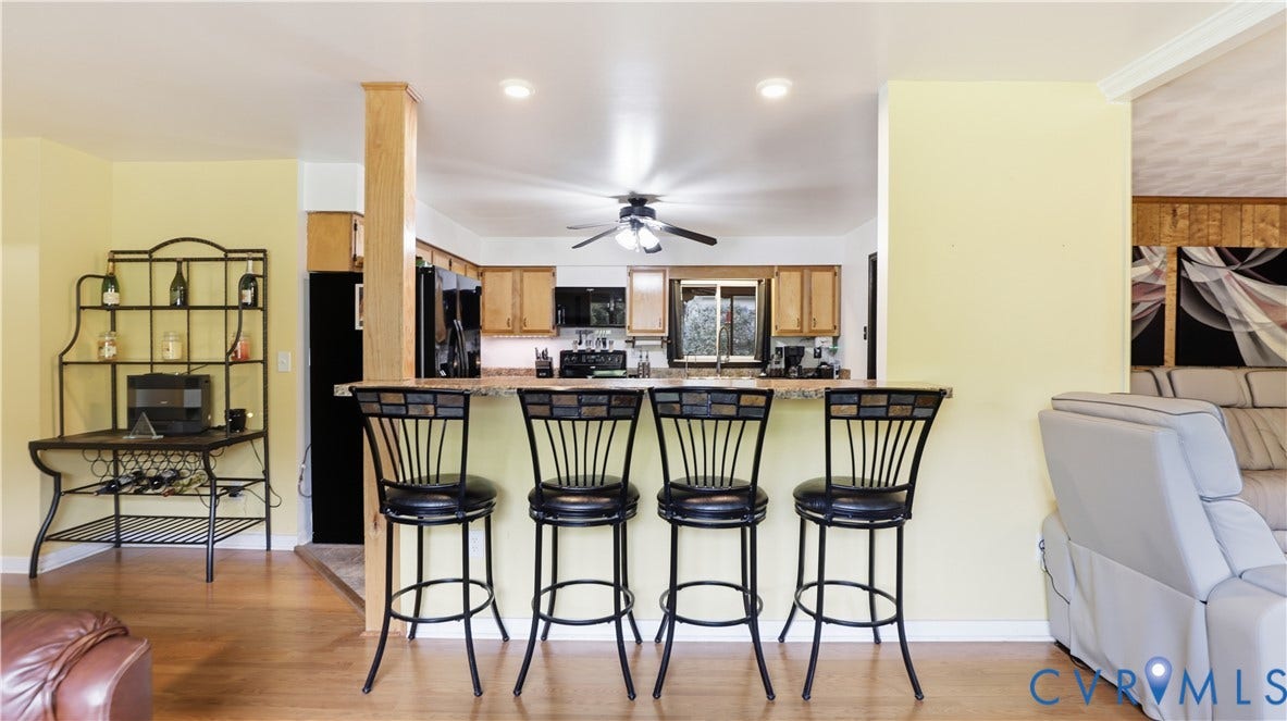 11201 Monday Way, Chesterfield, VA 23112 Kitchen counter seating with a solid surface countertop and wood-finish flooring