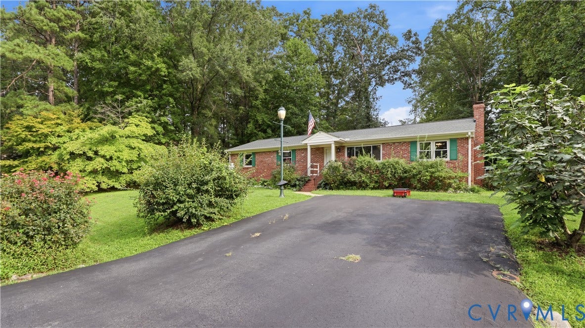 11201 Monday Way, Chesterfield, VA 23112 Brick exterior with green shutters, a paved driveway, and mature landscaping