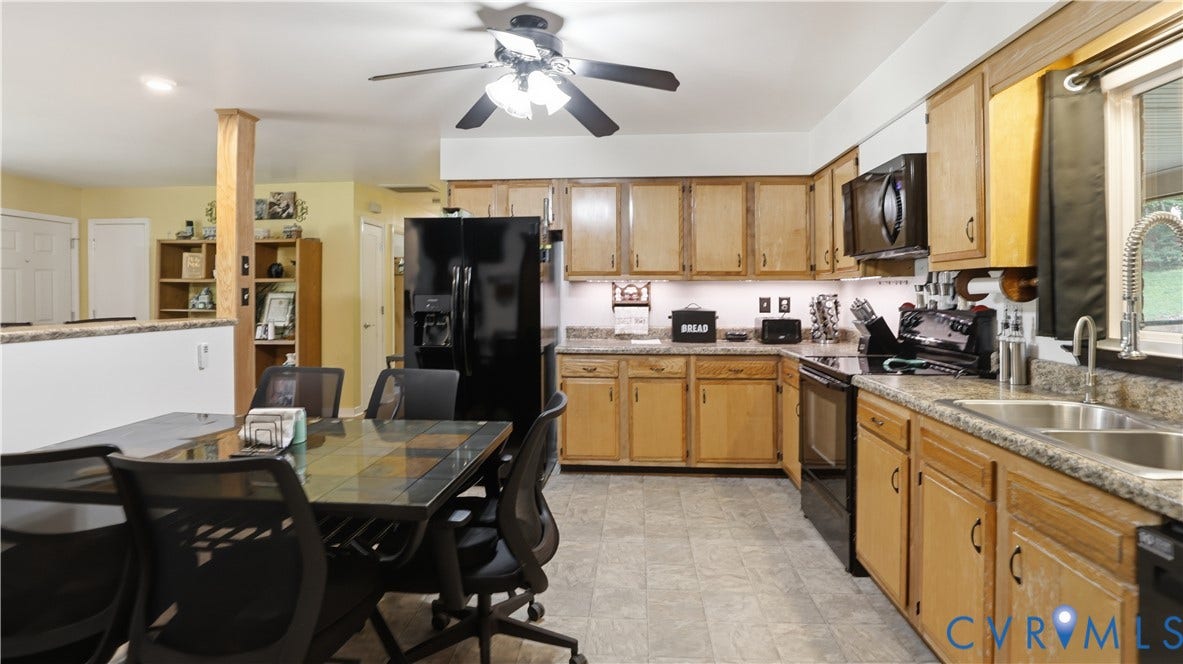 11201 Monday Way, Chesterfield, VA 23112 Kitchen featuring wood-finish cabinetry, black appliances, a double basin sink, and ample counter space