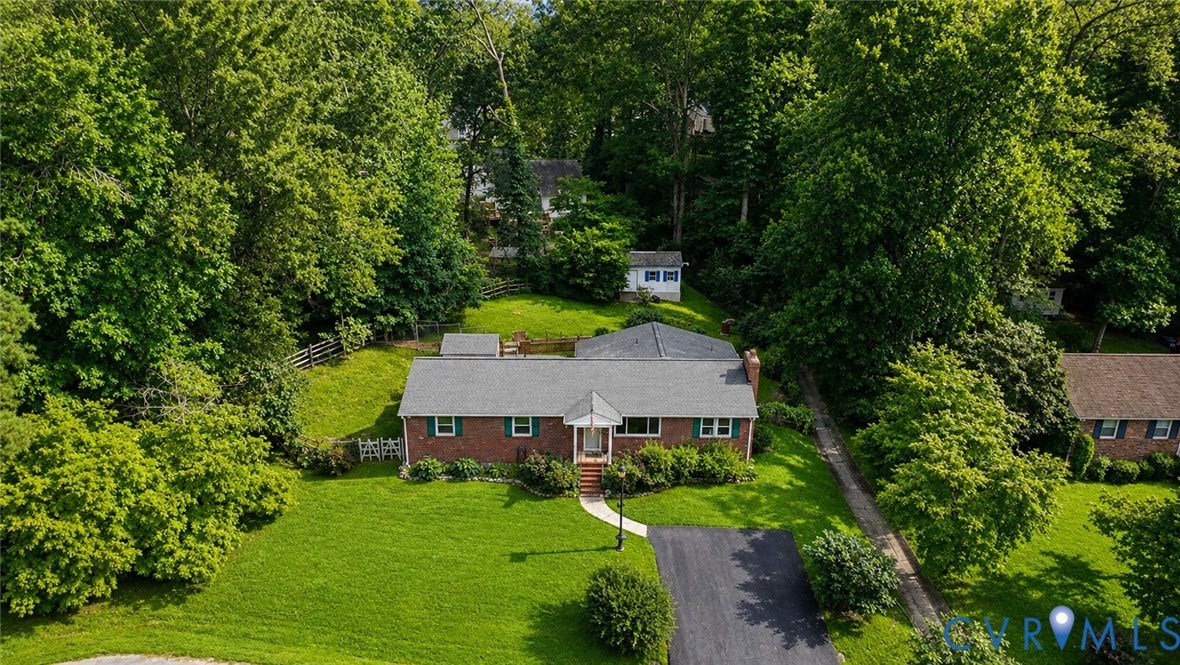 11201 Monday Way, Chesterfield, VA 23112 Brick exterior with a gray shingle roof, paved driveway, and manicured front lawn