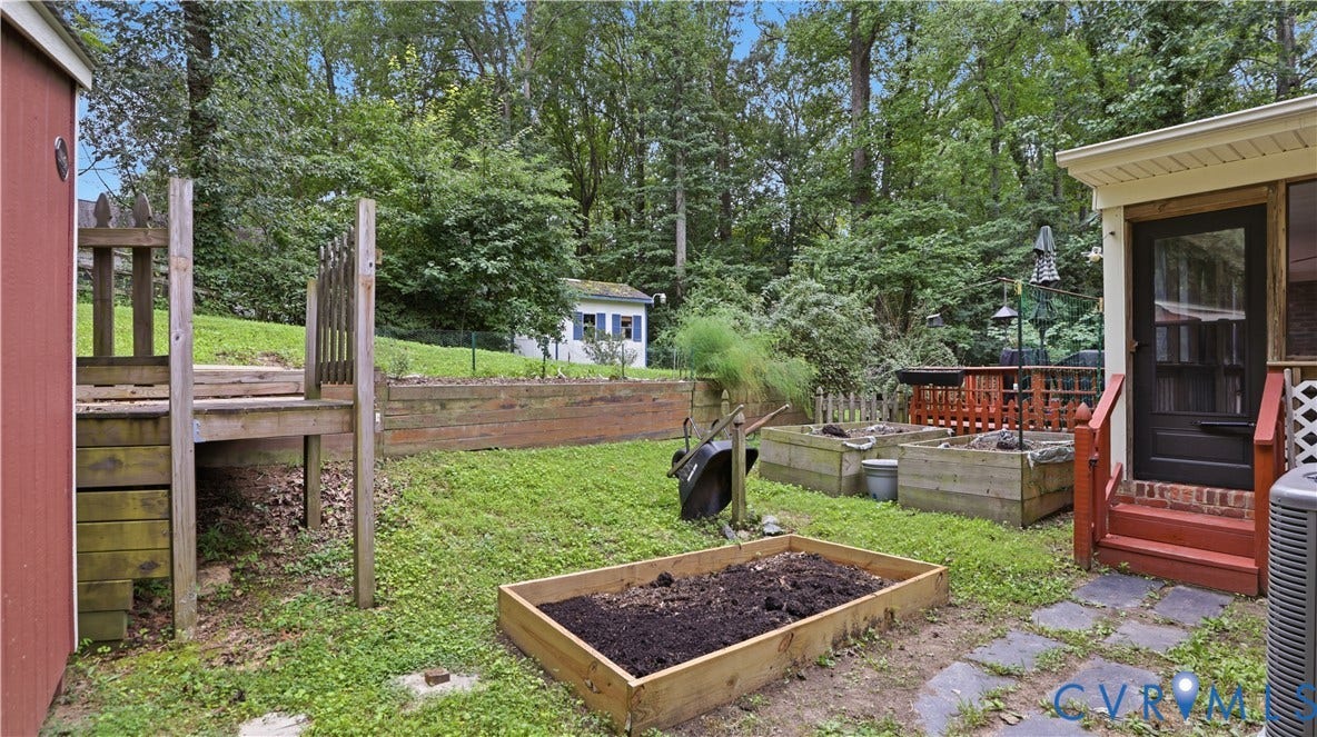 11201 Monday Way, Chesterfield, VA 23112 Screened porch with red-painted stairs, stone paver patio, multiple raised garden beds, and two storage sheds