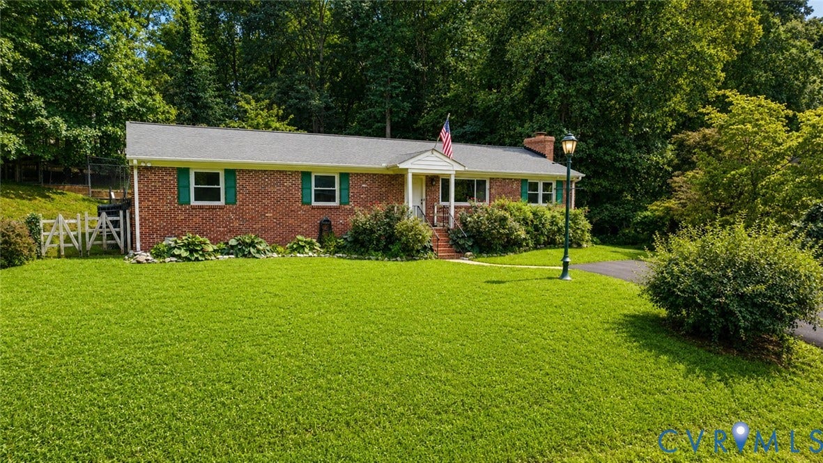 11201 Monday Way, Chesterfield, VA 23112 Brick exterior with green shutters, covered front porch, and mature landscaping