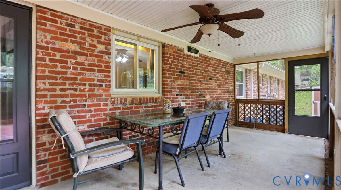 11201 Monday Way, Chesterfield, VA 23112 Covered concrete patio featuring a ceiling fan, exposed brick wall, and screened enclosure