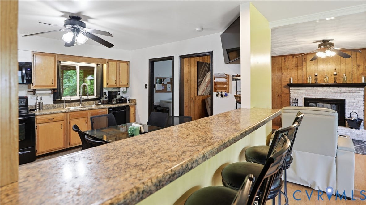 11201 Monday Way, Chesterfield, VA 23112 Kitchen featuring wood cabinetry, black appliances, and a window with a sink