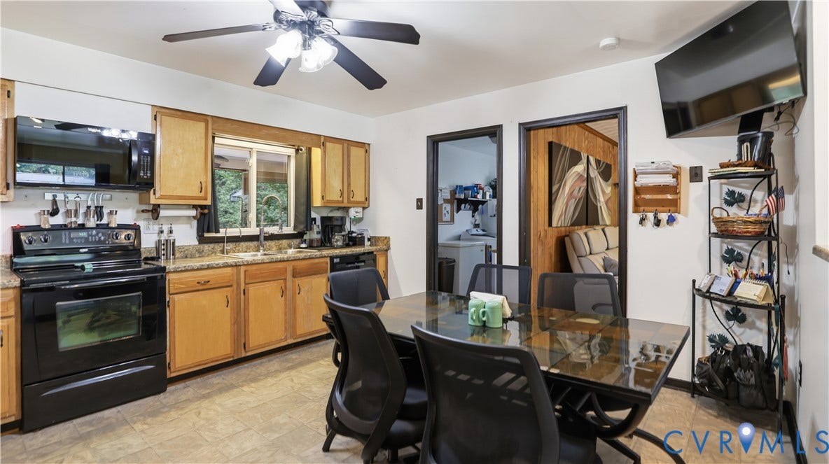 11201 Monday Way, Chesterfield, VA 23112 Kitchen featuring a black electric range, microwave, double-basin sink, and wood-finish cabinetry