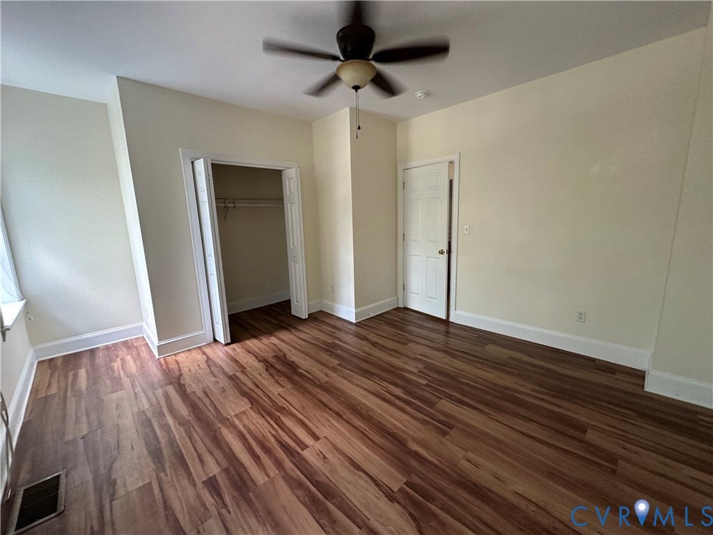 522.5 N 1st Street, Richmond, VA 23219 Wood-finish flooring, ceiling fan, white trim, and a built-in closet with shelving