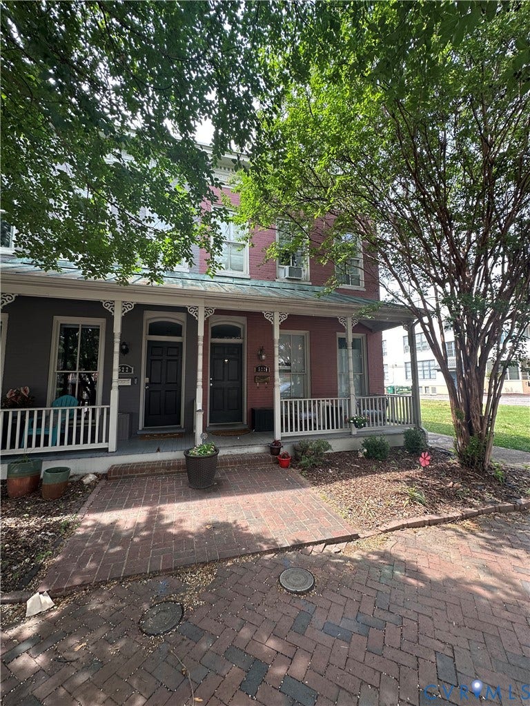 522.5 N 1st Street, Richmond, VA 23219 Brick facade with a covered front porch, white balustrade, and brick paver walkway
