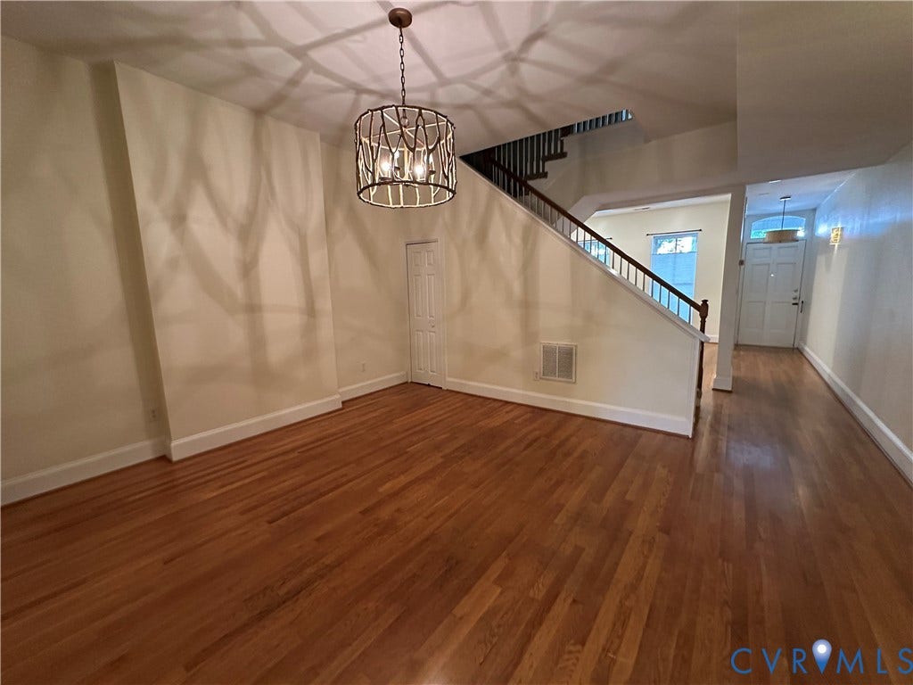 522.5 N 1st Street, Richmond, VA 23219 Wood-finish flooring throughout, wrought iron chandelier, and a wood staircase with white risers