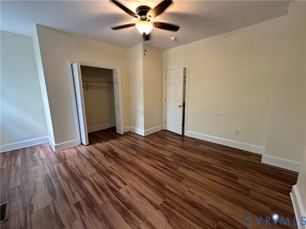 522.5 N 1st Street, Richmond, VA 23219 Wood-finish flooring, ceiling fan with integrated lighting, spacious closet with hanging rod, and white trim